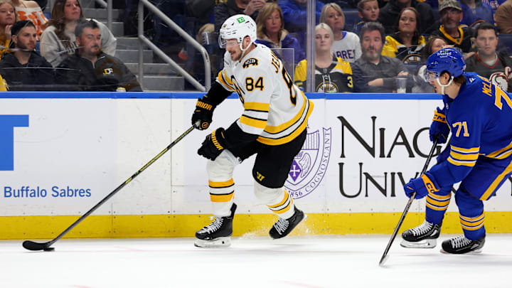 Mar 25, 2026; Buffalo, New York, USA;  Boston Bruins left wing Tanner Jeannot (84) carries the puck up ice during the first period against the Buffalo Sabres at KeyBank Center. Mandatory Credit: Timothy T. Ludwig-Imagn Images
