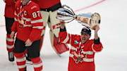 Team Canada forward Brad Marchand lifts the 4 Nations Face-Off trophy after beating Team USA in overtime.