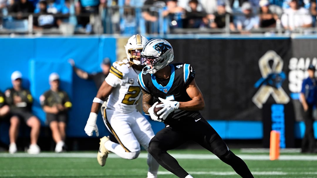 Carolina Panthers wide receiver Tetairoa McMillan (4) with the ball as New Orleans Saints safety Justin Reid (21) defends