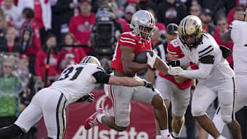 Nov 9, 2024; Columbus, Ohio, USA; Ohio State Buckeyes running back James Peoples (20) leaps away from Purdue Boilermakers defensive back Dillon Thieneman (31) during the second half  at Ohio Stadium. Mandatory Credit: Barbara Perenic/USA TODAY Network via Imagn Images