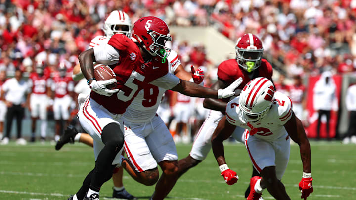 Sep 13, 2025; Tuscaloosa, Alabama, USA; Alabama Crimson Tide wide receiver Germie Bernard (5) avoids a tackle by Wisconsin Badgers cornerback Ricardo Hallman (2) during the second quarter at Saban Field at Bryant-Denny Stadium. Sep 13, 2025; Tuscaloosa, Alabama, USA; Alabama Crimson Tide wide receiver Germie Bernard (5) avoids a tackle by Wisconsin Badgers cornerback Ricardo Hallman (2) during the second quarter at Saban Field at Bryant-Denny Stadium.