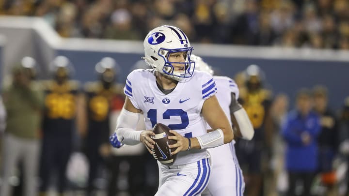 Nov 4, 2023; Morgantown, West Virginia, USA; Brigham Young Cougars quarterback Jake Retzlaff (12) drops back for a pass during the second quarter against the West Virginia Mountaineers at Mountaineer Field at Milan Puskar Stadium. Mandatory Credit: Ben Queen-USA TODAY Sports