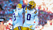 Nov 29, 2025; Norman, Oklahoma, USA;  Louisiana State Tigers defensive back A.J. Haulcy (13) and Louisiana State Tigers safety Tamarcus Cooley (0) react during the first half against the Oklahoma Sooners at Gaylord Family-Oklahoma Memorial Stadium. Mandatory Credit: Kevin Jairaj-Imagn Images
