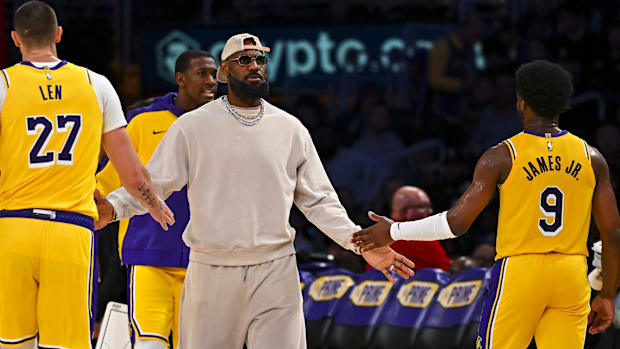 os Angeles, California, USA; Los Angeles Lakers forward LeBron James (23) fives guard Bronny James (9) and center Alex Len (2