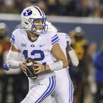 Nov 4, 2023; Morgantown, West Virginia, USA; Brigham Young Cougars quarterback Jake Retzlaff (12) drops back for a pass during the second quarter against the West Virginia Mountaineers at Mountaineer Field at Milan Puskar Stadium. 