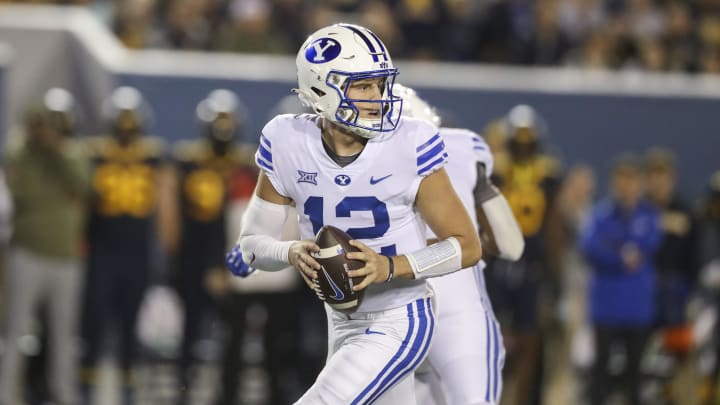 Nov 4, 2023; Morgantown, West Virginia, USA; Brigham Young Cougars quarterback Jake Retzlaff (12) drops back for a pass during the second quarter against the West Virginia Mountaineers at Mountaineer Field at Milan Puskar Stadium. 