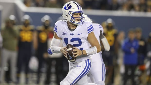 BYU Cougars quarterback Jake Retzlaff attempts a pass during a college football game in the Big 12.