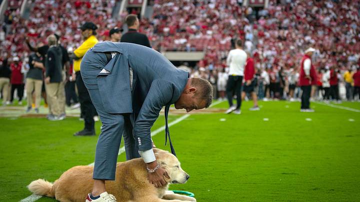 Sep 28, 2024; Tuscaloosa, Alabama, USA; ESPN’s Kirk Herbstreit pets his dog Ben on the field before a game between the Georgia Bulldogs and Alabama Crimson Tide at Bryant-Denny Stadium.