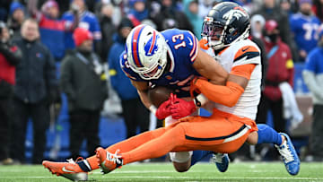 Jan 12, 2025; Orchard Park, New York, USA; Buffalo Bills wide receiver Mack Hollins (13) is tackled by Denver Broncos cornerback Pat Surtain II (2) during the fourth quarter in an AFC wild card game at Highmark Stadium. 