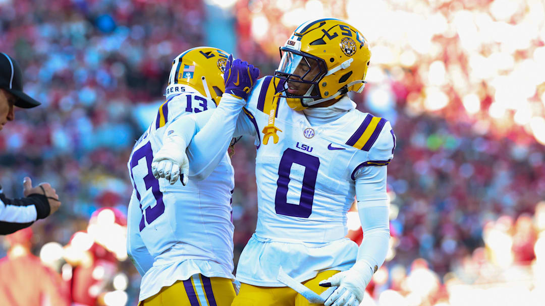 Nov 29, 2025; Norman, Oklahoma, USA;  Louisiana State Tigers defensive back A.J. Haulcy (13) and Louisiana State Tigers safety Tamarcus Cooley (0) react during the first half against the Oklahoma Sooners at Gaylord Family-Oklahoma Memorial Stadium. Mandatory Credit: Kevin Jairaj-Imagn Images