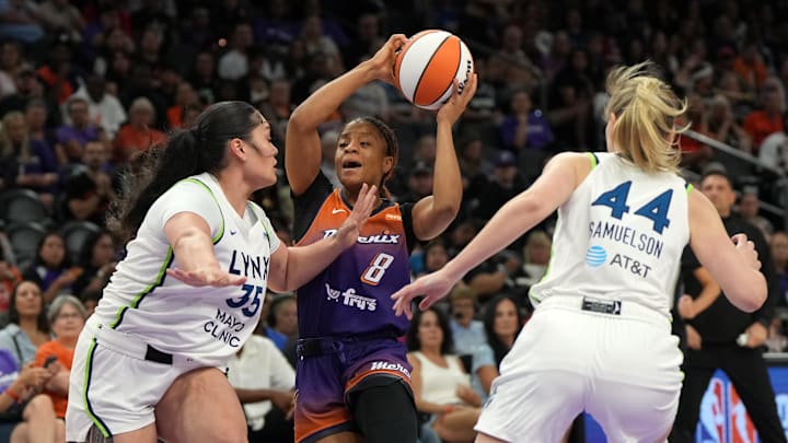 May 30, 2025; Phoenix, Arizona, USA; Phoenix Mercury guard Monique Akoa Makani (8) drives between Minnesota Lynx forward Alissa Pili (35) and forward Karlie Samuelson (44) in the first half at Footprint Center. Mandatory Credit: Rick Scuteri-Imagn Images
