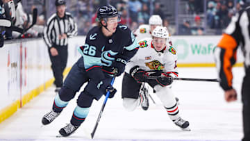 Nov 3, 2025; Seattle, Washington, USA; Seattle Kraken center Ryan Winterton (26) drives the puck in the second period against the Chicago Blackhawks at Climate Pledge Arena. Mandatory Credit: Kevin Ng-Imagn Images