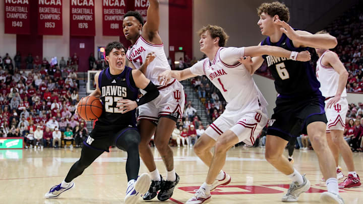 Jan 4, 2026; Bloomington, Indiana, USA; Washington Huskies guard JJ Mandaquit (23) goes to the basket against Indiana Hoosiers guard Nick Dorn (7) during the second half at Simon Skjodt Assembly Hall. Mandatory Credit: Robert Goddin-Imagn Images