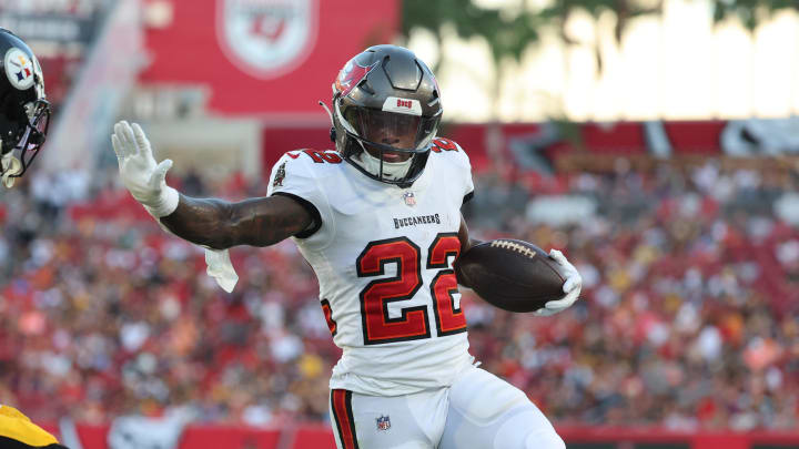 Aug 11, 2023; Tampa, Florida, USA; Tampa Bay Buccaneers running back Chase Edmonds (22) runs with the ball as Pittsburgh Steelers cornerback James Pierre (42) defends during the first half at Raymond James Stadium. Mandatory Credit: Kim Klement Neitzel-USA TODAY Sports