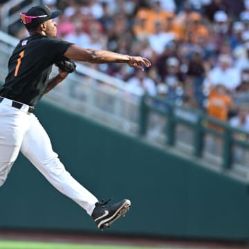 Jun 24, 2024; Omaha, NE, USA;  Tennessee Volunteers second baseman Christian Moore (1) completes a double play against the Texas A&M Aggies during the third inning at Charles Schwab Field Omaha. Mandatory Credit: Steven Branscombe-USA TODAY Sports