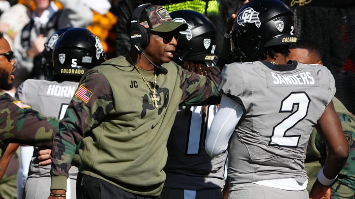 Nov 11, 2023; Boulder, Colorado, USA; Colorado Buffaloes quarterback Shedeur Sanders (2) celebrates his touchdown with head coach Deion Sanders in the first half against the Arizona Wildcats at Folsom Field