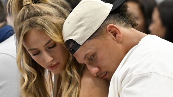 May 26, 2024; Dallas, Texas, USA; Kansas City Chiefs quarterback Patrick Mahomes (right) and his wife Brittany Mahomes (left) check their phone during the second half of the game between the Dallas Mavericks and the Minnesota Timberwolves in game three of the western conference finals for the 2024 NBA playoffs at American Airlines Center.