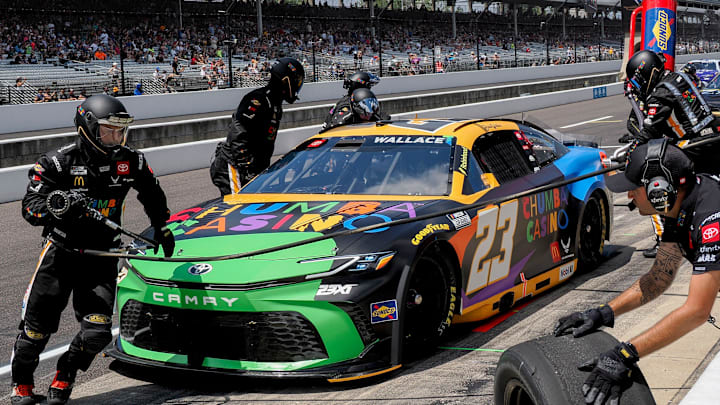 NASCAR Cup Series driver Bubba Wallace (23) makes a pit stop Sunday, July 27, 2025, during the Brickyard 400 at Indianapolis Motor Speedway.
