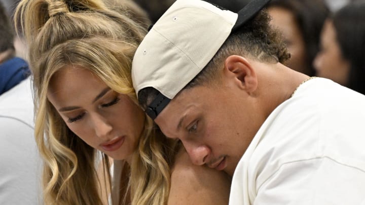 May 26, 2024; Dallas, Texas, USA; Kansas City Chiefs quarterback Patrick Mahomes (right) and his wife Brittany Mahomes (left) check their phone during the second half of the game between the Dallas Mavericks and the Minnesota Timberwolves in game three of the western conference finals for the 2024 NBA playoffs at American Airlines Center. 