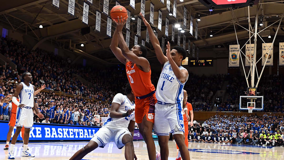 Feb 14, 2026; Durham, North Carolina, USA; Clemson Tigers forward RJ Godfrey (0) shoots in front of Duke Blue Devils guard Caleb Foster (1) during the first half at Cameron Indoor Stadium. Mandatory Credit: Rob Kinnan-Imagn Images Feb 14, 2026; Durham, North Carolina, USA; Clemson Tigers forward RJ Godfrey (0) shoots in front of Duke Blue Devils guard Caleb Foster (1) during the first half at Cameron Indoor Stadium. Mandatory Credit: Rob Kinnan-Imagn Images