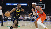 Nov 11, 2025; Oklahoma City, Oklahoma, USA; Golden State Warriors forward Jonathan Kuminga (1) moves the ball down the court beside Oklahoma City Thunder guard Shai Gilgeous-Alexander (2) during the second half at Paycom Center. Mandatory Credit: Alonzo Adams-Imagn Images