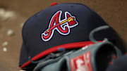 Apr 26, 2014; Atlanta, GA, USA; Detailed view of Atlanta Braves hat and glove in the dugout against the Cincinnati Reds in the third inning at Turner Field. Mandatory Credit: Brett Davis-Imagn Images