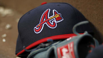 Apr 26, 2014; Atlanta, GA, USA; Detailed view of Atlanta Braves hat and glove in the dugout against the Cincinnati Reds in the third inning at Turner Field. Mandatory Credit: Brett Davis-Imagn Images