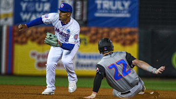 Rocket City Trash Pandas' right fielder Tucker Flint (22) slides into second base during the last opening day game at the Tennessee Smokies Stadium on Friday, April 5, 2024 in Kodak, Tenn.