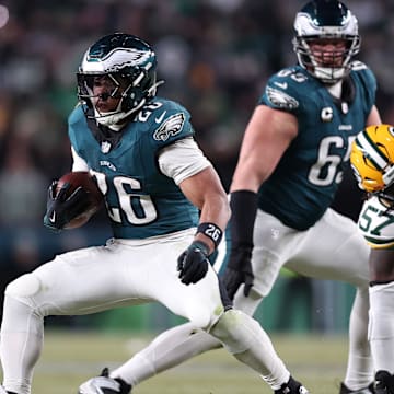 Jan 12, 2025; Philadelphia, Pennsylvania, USA; Philadelphia Eagles running back Saquon Barkley (26) rushes the ball against Green Bay Packers cornerback Keisean Nixon (25) in the fourth quarter in an NFC wild card game at Lincoln Financial Field. Mandatory Credit: Bill Streicher-Imagn Images