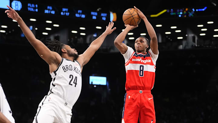Oct 14, 2024; Brooklyn, New York, USA; Washington Wizards guard Bub Carrington (8) shoots a jump shot over Brooklyn Nets small guard Cam Thomas (24) during the second half at Barclays Center. Mandatory Credit: Gregory Fisher-Imagn Images