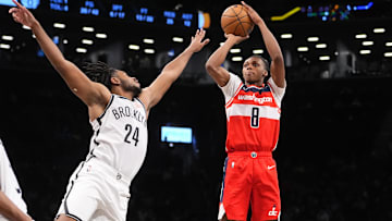 Oct 14, 2024; Brooklyn, New York, USA; Washington Wizards guard Bub Carrington (8) shoots a jump shot over Brooklyn Nets small guard Cam Thomas (24) during the second half at Barclays Center. Mandatory Credit: Gregory Fisher-Imagn Images