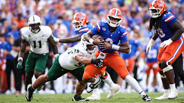 Gator quarterback DJ Lagway is tackled by USF defensive tackle Devin Lee in The Swamp Saturday.