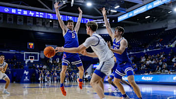 Air Force forward Caleb Walker passes the ball as Boise State guard RJ Keene II (5) and forward Andrew Meadow (13) defend.