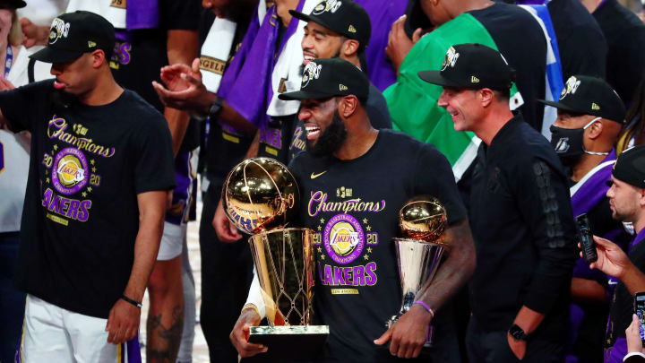 Los Angeles Lakers forward LeBron James (23) smiles while holding the MVP and Finals trophies after game six of the 2020 NBA Finals at AdventHealth Arena. The Los Angeles Lakers won 106-93 to win the series. Mandatory Credit: