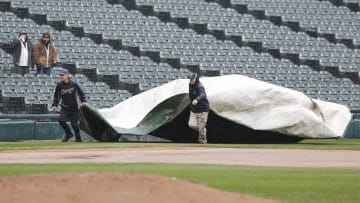 Apr 1, 2024; Chicago, Illinois, USA; Grounds crew covers the field with a tarp during a rain delay in the eight inning of a baseball game between the Chicago White Sox and Atlanta Braves at Guaranteed Rate Field. Mandatory Credit: Kamil Krzaczynski-USA TODAY Sports