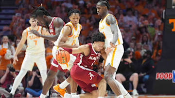 Alabama guard Mark Sears (1) dribbles into Tennessee's Felix Okpara (34) during a men’s college basketball game between Tennessee and Alabama at Thompson-Boling Arena at Food City Center, Saturday, March 1, 2025.