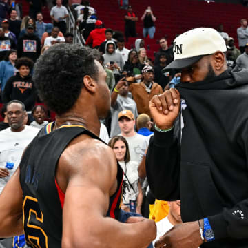Mar 28, 2023; Houston, TX, USA; McDonald's All American West guard Bronny James (6) speaks with his father, LeBron James of the Los Angeles Lakers, after the game against the McDonald's All American East at Toyota Center. Mandatory Credit: Maria Lysaker-USA TODAY Sports