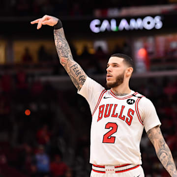 Feb 28, 2025; Chicago, Illinois, USA; Chicago Bulls forward Lonzo Ball (2) hits a three point shot against Toronto Raptors guard Jamal Shead (23) during overtime at the United Center. Mandatory Credit: Patrick Gorski-Imagn Images
