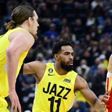 Feb 3, 2023; Salt Lake City, Utah, USA; Atlanta Hawks guard Trae Young (11) dribbles around Utah Jazz guard Mike Conley (11) and forward/center Kelly Olynyk (41) during the first half at Vivint Arena. Mandatory Credit: Christopher Creveling-USA TODAY Sports