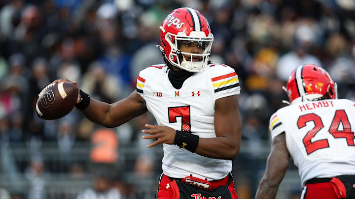 Nov 30, 2024; University Park, Pennsylvania, USA; Maryland Terrapins quarterback MJ Morris (7) rolls out to throw a pass against the Penn State Nittany Lions during the first quarter at Beaver Stadium. Mandatory Credit: Matthew O'Haren-Imagn Images