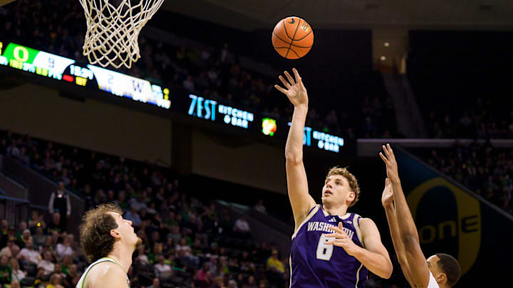 Washington forward Hannes Steinbach, center, goes up for a shot as the Oregon Ducks host the Washington Huskies on March 7, 2026, at Matthew Knight Arena in Eugene, Oregon.