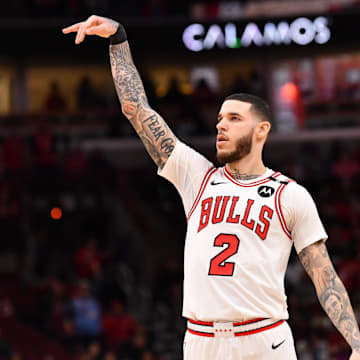 Feb 28, 2025; Chicago, Illinois, USA; Chicago Bulls forward Lonzo Ball (2) hits a three point shot against Toronto Raptors guard Jamal Shead (23) during overtime at the United Center. Mandatory Credit: Patrick Gorski-Imagn Images