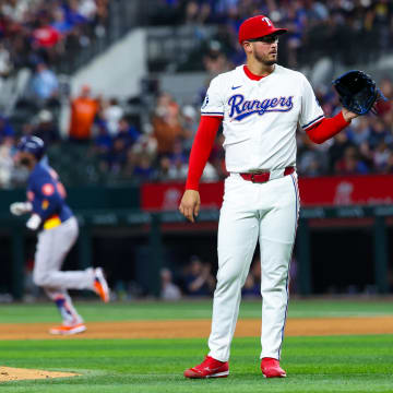 Aug 6, 2024; Arlington, Texas, USA; Texas Rangers starting pitcher Dane Dunning (33) reacts after giving up a home run to Houston Astros left fielder Yordan Alvarez (back) during the ninth inning at Globe Life Field. Mandatory Credit: Kevin Jairaj-USA TODAY Sports