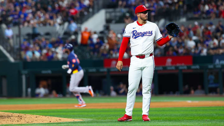 Aug 6, 2024; Arlington, Texas, USA; Texas Rangers starting pitcher Dane Dunning (33) reacts after giving up a home run to Houston Astros left fielder Yordan Alvarez (back) during the ninth inning at Globe Life Field. Mandatory Credit: Kevin Jairaj-USA TODAY Sports