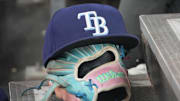 Sep 26, 2025; Toronto, Ontario, CAN; The hat and glove of Tampa Bay Rays third baseman Junior Caminero (13) in the dugout during the game against the Toronto Blue Jays at Rogers Centre. 