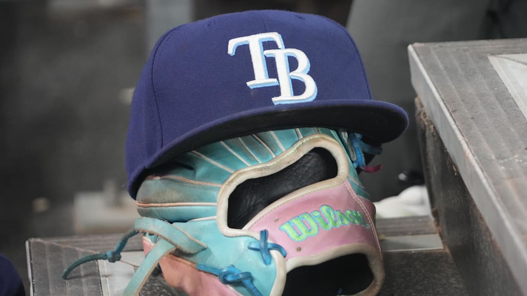 Sep 26, 2025; Toronto, Ontario, CAN; The hat and glove of Tampa Bay Rays third baseman Junior Caminero (13) in the dugout during the game against the Toronto Blue Jays at Rogers Centre. Mandatory Credit: John E. Sokolowski-Imagn Images