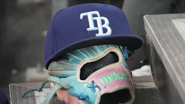 Sep 26, 2025; Toronto, Ontario, CAN; The hat and glove of Tampa Bay Rays third baseman Junior Caminero (13) in the dugout during the game against the Toronto Blue Jays at Rogers Centre.
