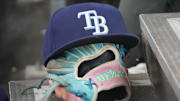 Sep 26, 2025; Toronto, Ontario, CAN; The hat and glove of Tampa Bay Rays third baseman Junior Caminero (13) in the dugout during the game against the Toronto Blue Jays at Rogers Centre. 