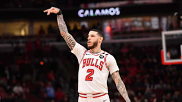Feb 28, 2025; Chicago, Illinois, USA; Chicago Bulls forward Lonzo Ball (2) hits a three point shot against Toronto Raptors guard Jamal Shead (23) during overtime at the United Center. Mandatory Credit: Patrick Gorski-Imagn Images
