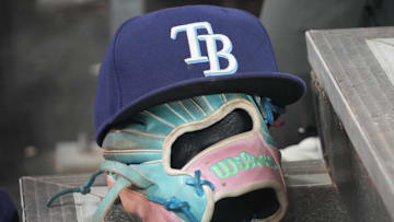 Sep 26, 2025; Toronto, Ontario, CAN; The hat and glove of Tampa Bay Rays third baseman Junior Caminero (13) in the dugout during the game against the Toronto Blue Jays at Rogers Centre. 